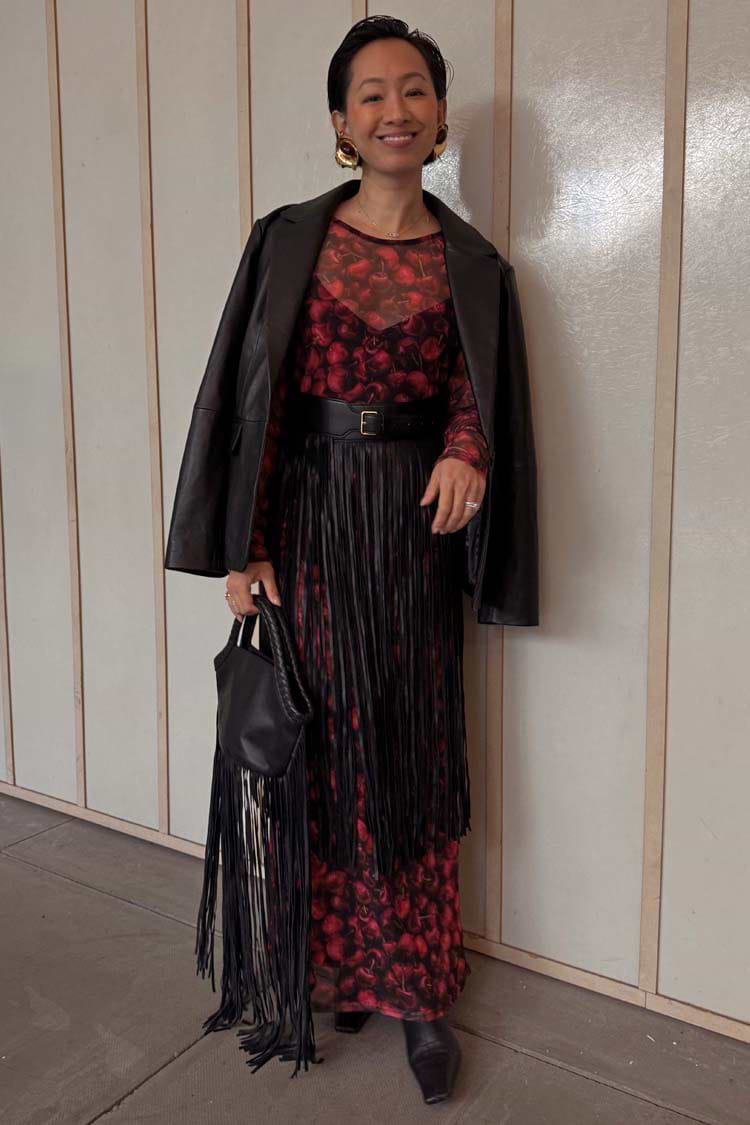 Black Leather Blazer in a relaxed fit, a transeasonal investment piece styled over a cherry print dress with fringe.