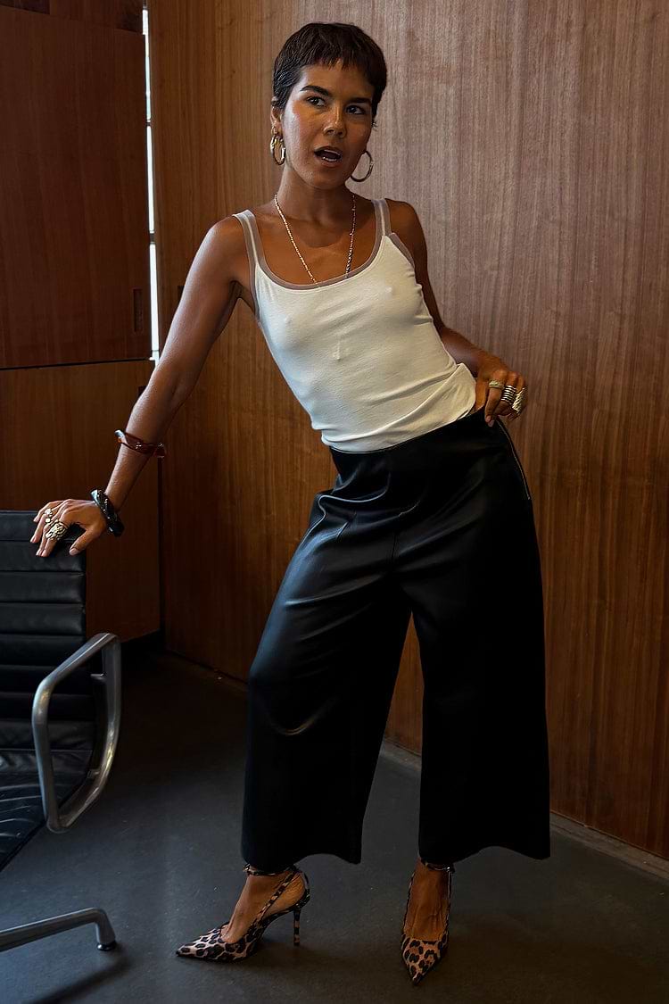 Black Vegan Leather Culottes with a wide leg and front crease, styled with leopard print heels.