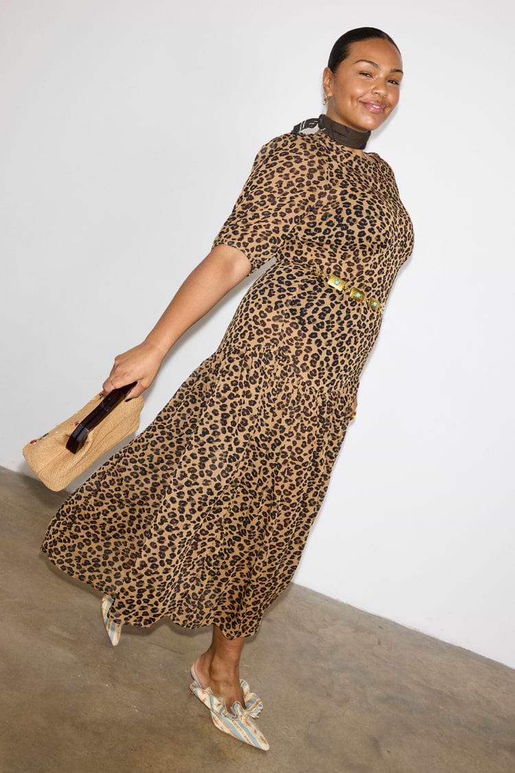 Leopard Lucia Sheer Midaxi Dress with puff sleeves and a tiered skirt, styled with a gold belt and neck scarf.