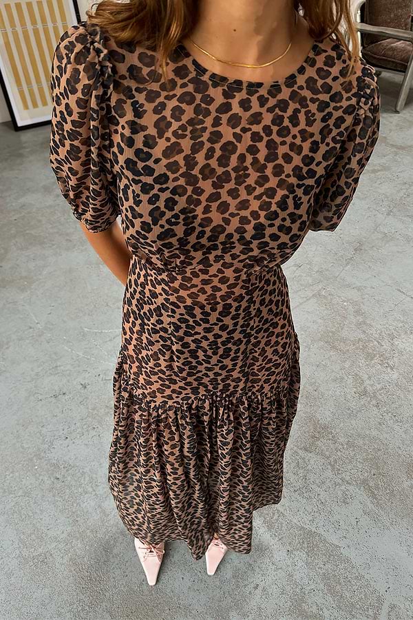 Sheer Leopard Lucia Dress featuring puff sleeves and a tiered skirt in an iconic leopard print.