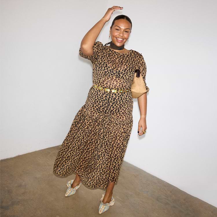 Iconic Leopard Lucia sheer dress with puff sleeves and a tiered skirt, styled with a gold belt.