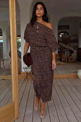 Lucia Leopard Tilly Dress in iconic leopard print plisse, styled off-the-shoulder for a multi-wear look on a wooden deck.