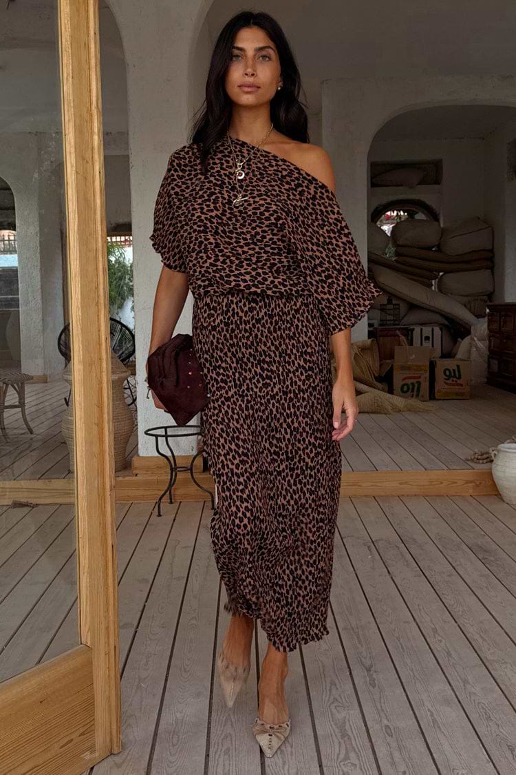 Lucia Leopard Tilly Dress in iconic leopard print plisse, styled off-the-shoulder for a multi-wear look on a wooden deck.