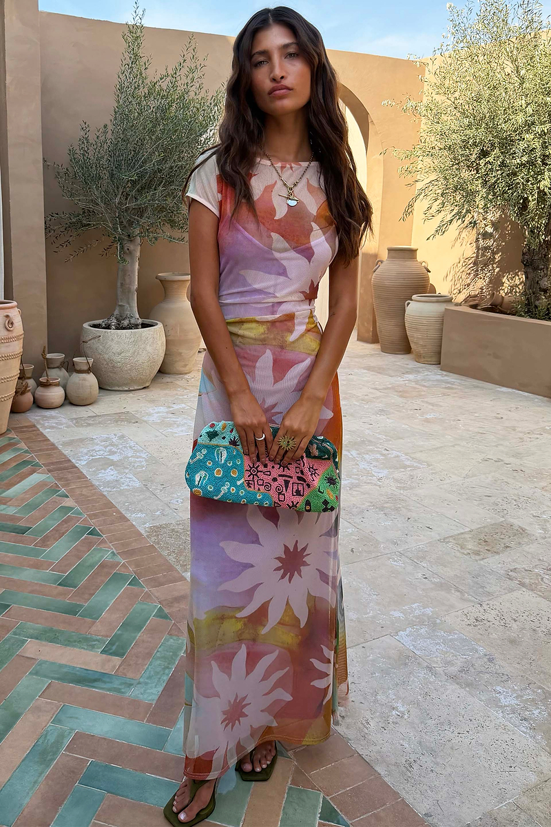 Abstract Soleil Luna Mesh Dress featuring multicoloured sun motifs on sheer mesh with short sleeves.
