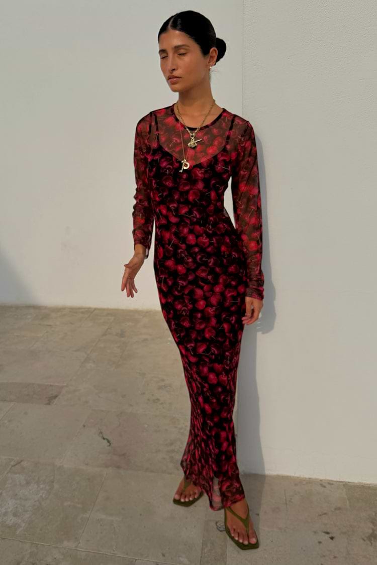 Cherry Mesh Soho Dress in a red digital cherry print with long sleeves and a sheer midaxi silhouette.