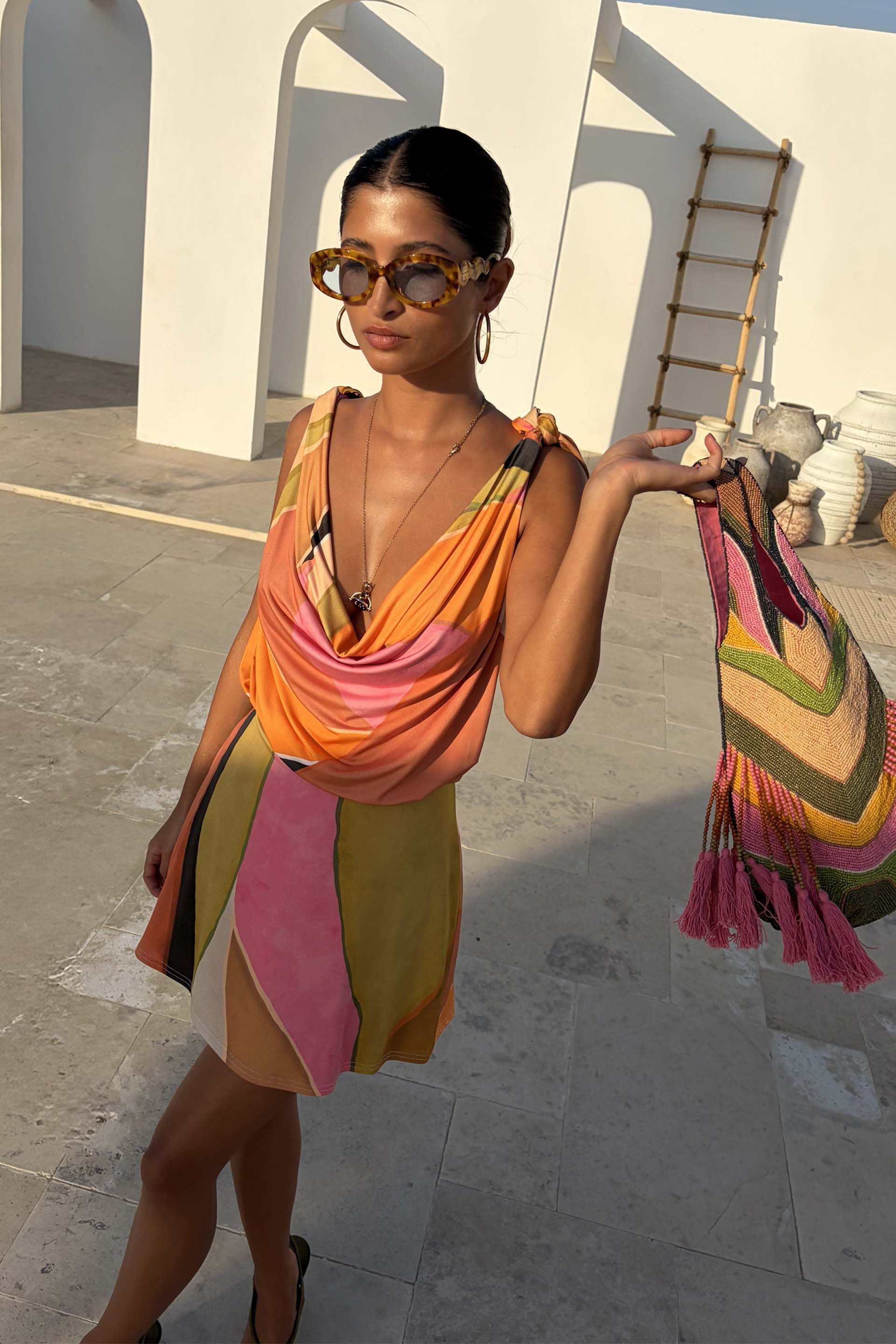 Green Abstract Leila Mini Dress with a cowl neck and adjustable multi-wear straps in a colourful print.