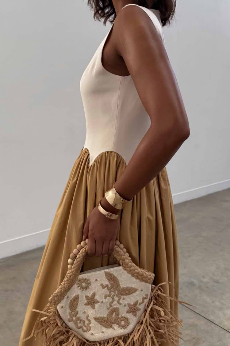 Camel Monika Midaxi Dress with a cream corset-style bodice, scalloped edging and a pleated camel-coloured skirt.