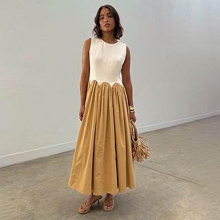 Camel Monika Dress with a white corset-style top, scalloped waist, and a beige pleated cotton midi skirt.