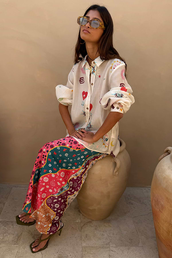 Morocco Charms Marley Shirt in cream with red hearts and sun motifs, worn with a vibrant printed maxi skirt.