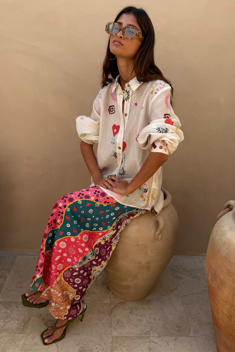 Morocco Charms Marley Shirt in cream with red hearts and sun motifs, worn with a vibrant printed maxi skirt.