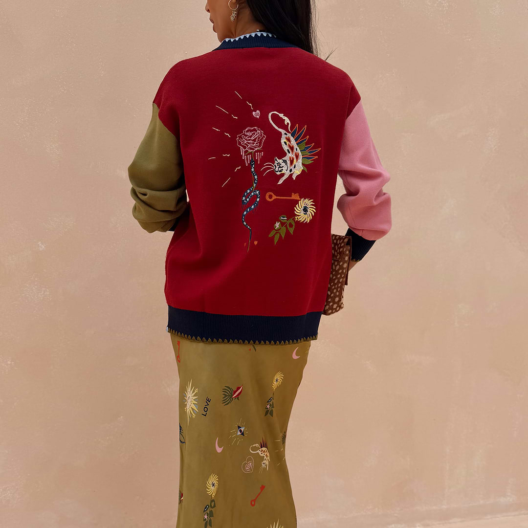 Mystical Martha Cardigan with embroidered back motifs, multicoloured sleeves and contrast blanket stitching.