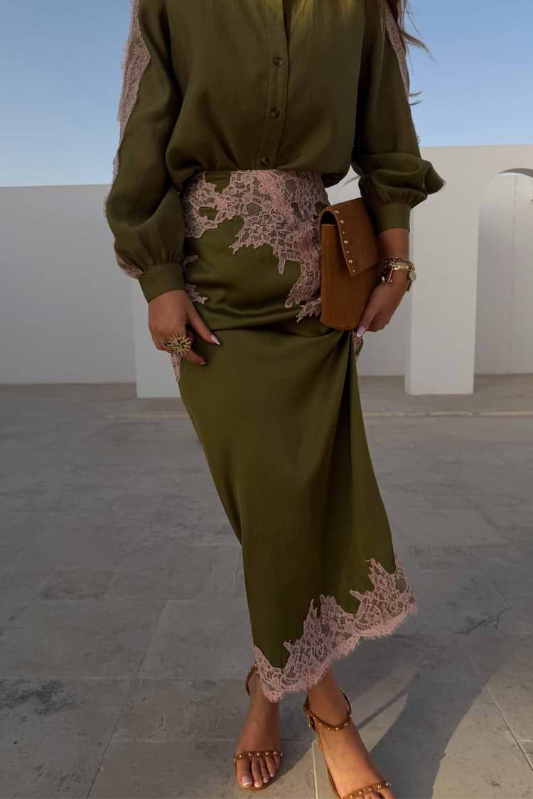 Olive green satin Lily Skirt with pink lace detailing at the waist and hem, styled with a matching blouse.