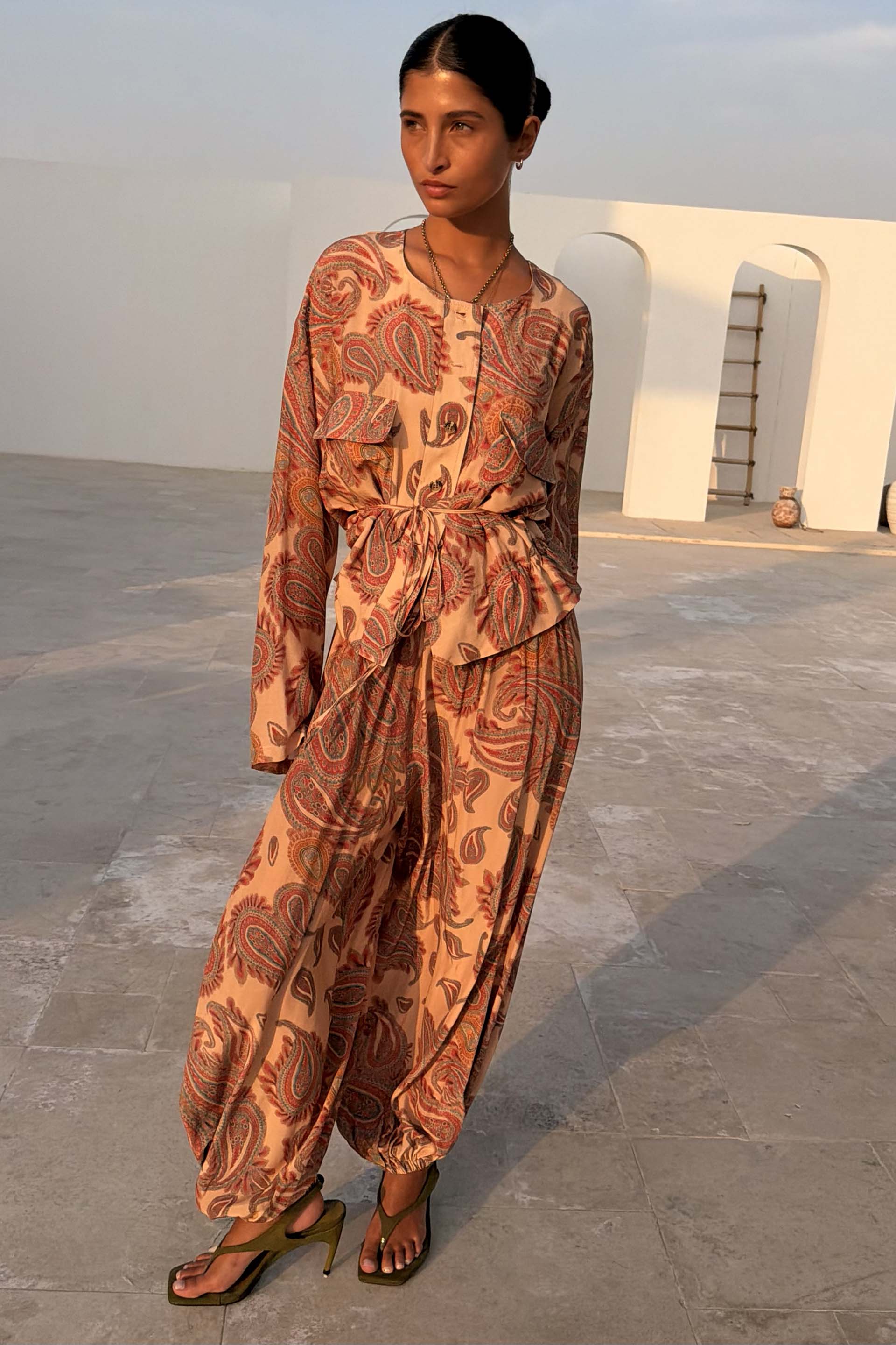 Peach Paisley Balloon Trousers and matching co-ord top with classic motifs in a sunlit outdoor setting.
