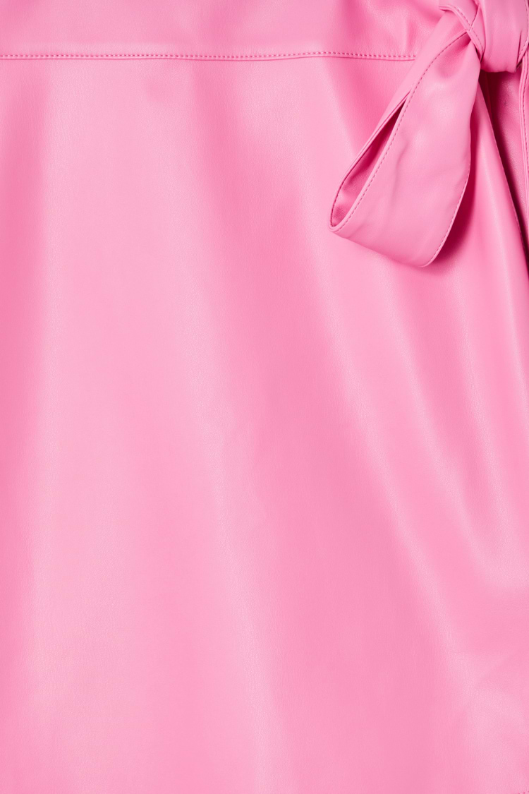 Detail of the pink vegan leather fabric and wrap tie fastening on the iconic Mini Jaspre Skirt.