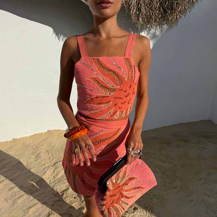 Pink Sol Beaded Top with a hand-embroidered sun motif and gold sequins, styled for a beach vacation.