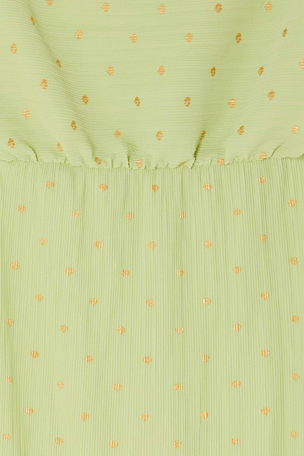 Pistachio green plisse fabric detail of the Tilly Dress featuring subtle gold flecks and an elasticated waistband.