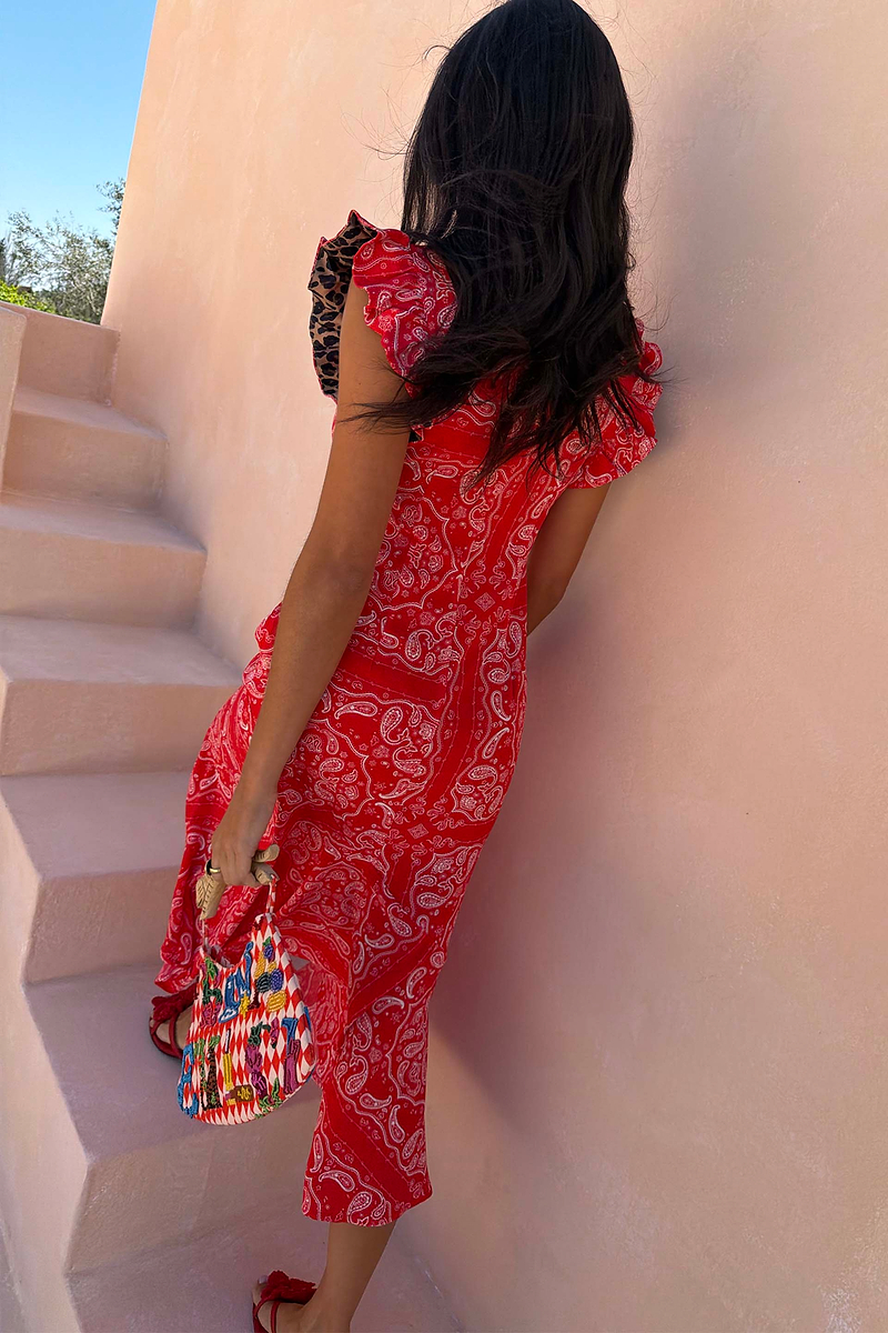 Red Bandana Remi Dress with leopard sleeve frills and an a-symmetrical skirt, shown from behind on a model.