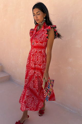 Red Bandana Remi Dress featuring a ruffled neck and leopard print sleeves, styled with a patterned clutch.