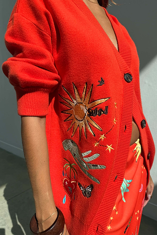 Red Celestial Cardigan featuring embroidered sun, heart and palm motifs on a soft knit with button-up front.