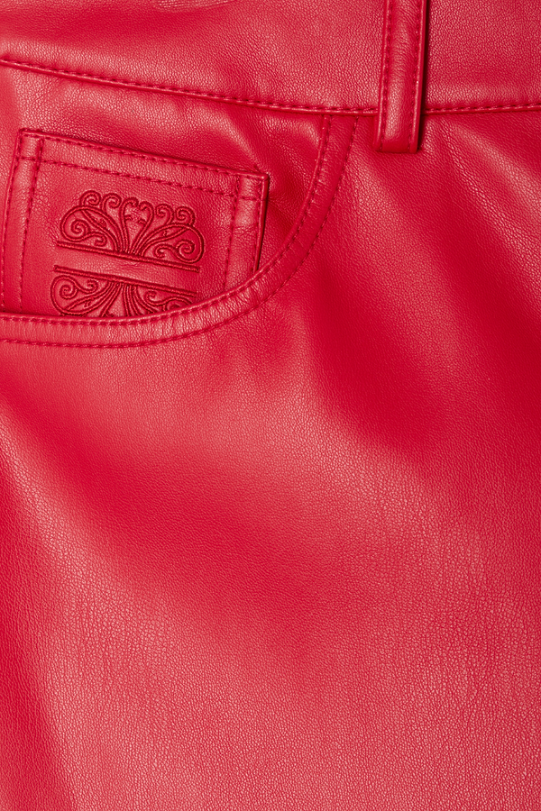 Deep red vegan leather trousers featuring an embroidered pocket logo detail.