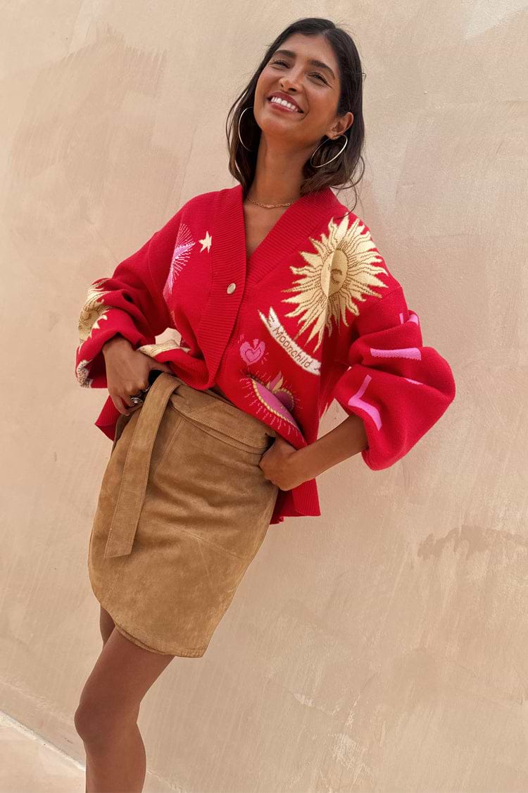 Tan Suede Mini Jaspre wrap skirt on a model styled with a red celestial print cardigan.