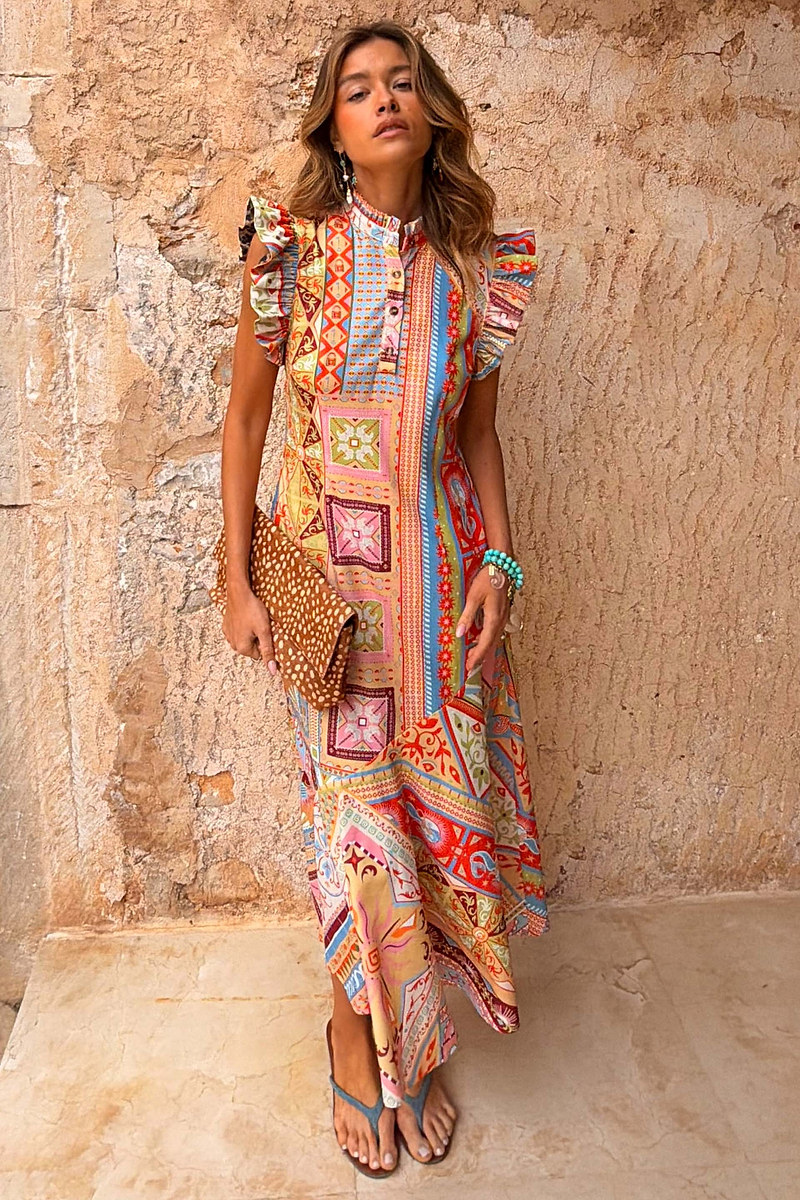 Dolce Vita Remi Dress in a sunset-toned patchwork print with a high neck and statement ruffle sleeves.