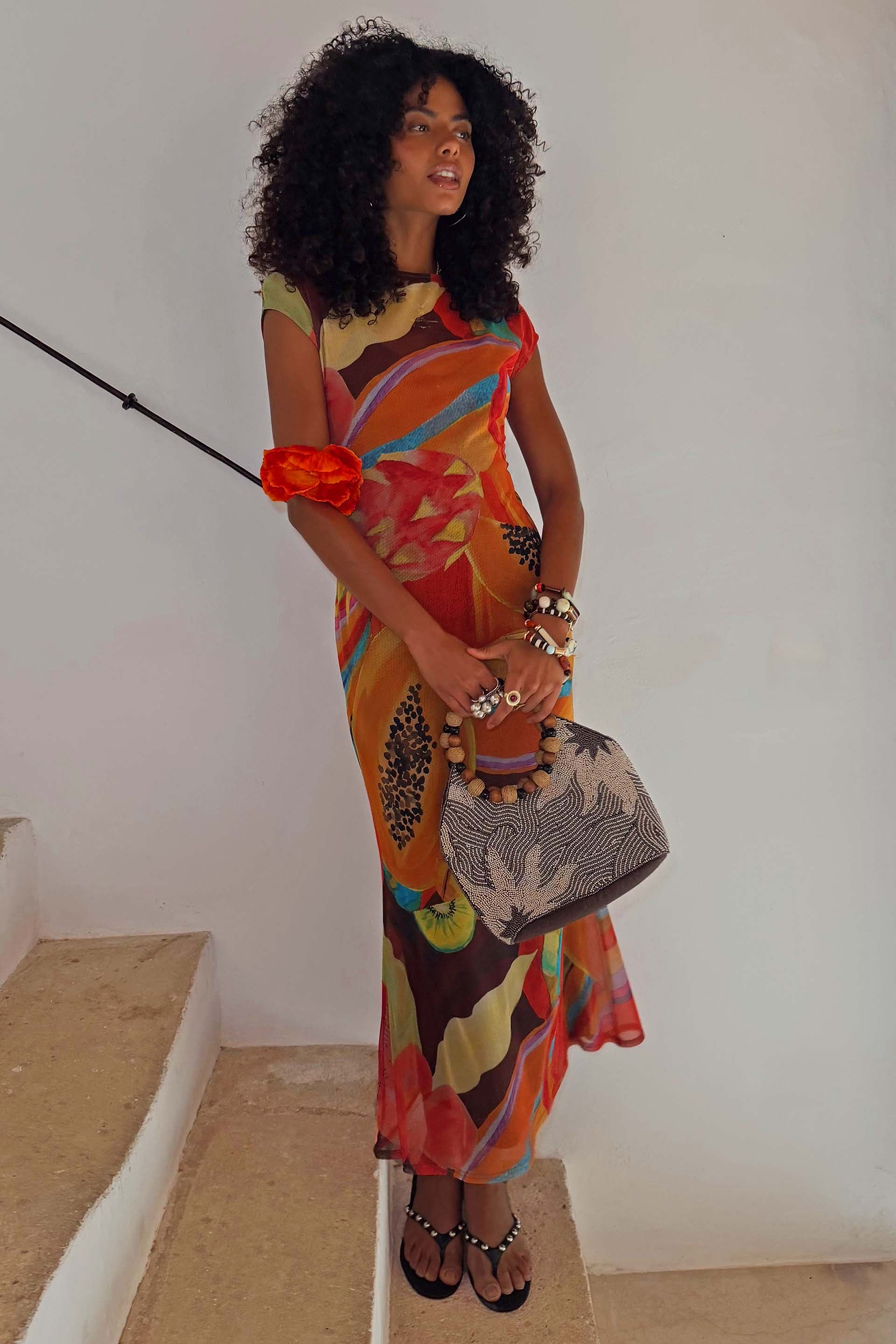 Rio Mesh Dress featuring oversized fruit motifs and warm colour blocks on a stretch mesh base, styled on a model.