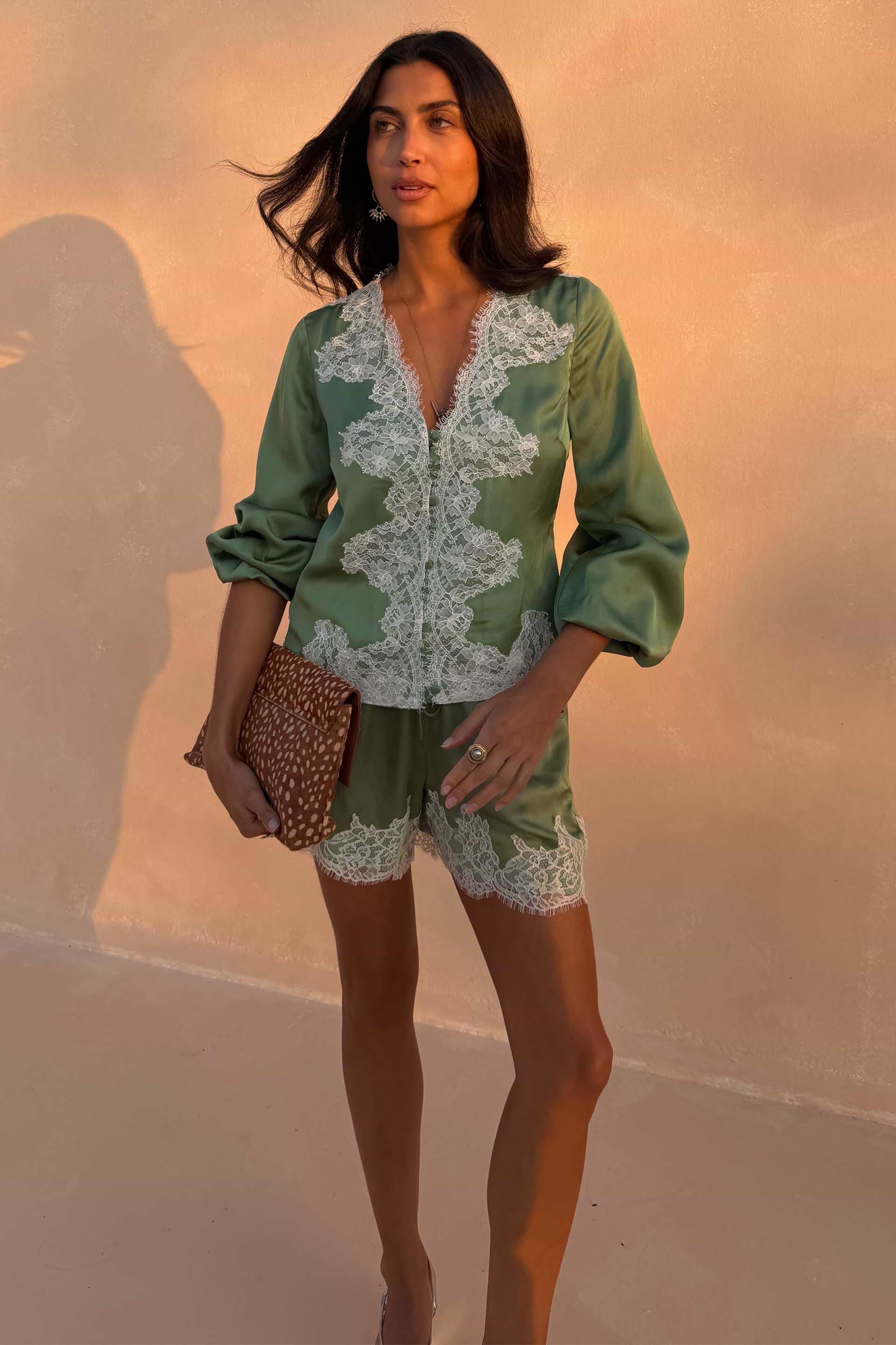 Green Lace Romi Top in soft green satin with white lace detailing and voluminous sleeves, designed in London.