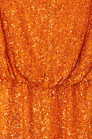 Orange Sequin Tilly Dress detail highlighting shimmering burnt orange sequins and an elasticated waist.