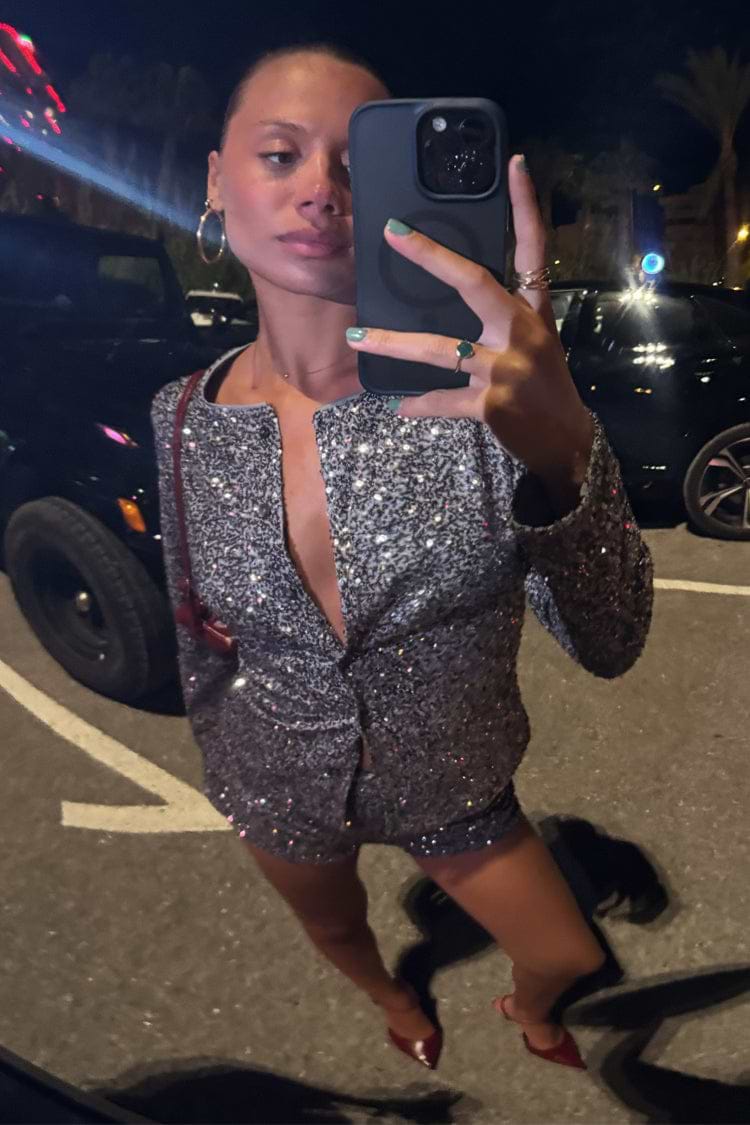 Gunmetal Alexa Sequin Cardigan and co-ord hot pants worn by a model taking a mirror selfie.