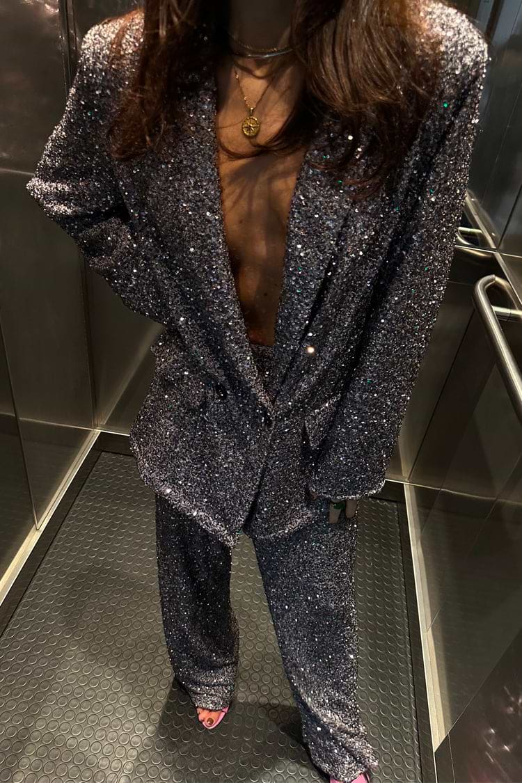 Gunmetal Sequin Freddie Trousers and matching blazer styled as a statement suit inside a lift.