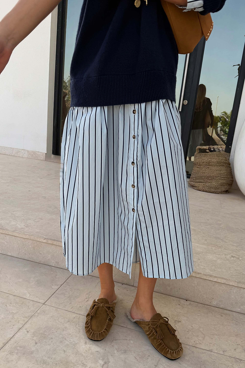 Navy Knit Jumper Dress with a blue striped cotton skirt and button-front detail, styled with loafers.