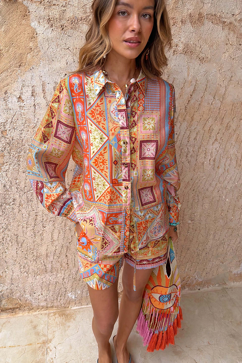 Dolce Vita Ellie Shorts in a colourful tile patchwork print, styled with a matching shirt for a co-ord look.
