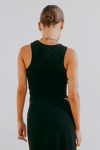 Black Sol Tank Top featuring a racerback with tonal embroidery, shown from the back in a ribbed black fabric.