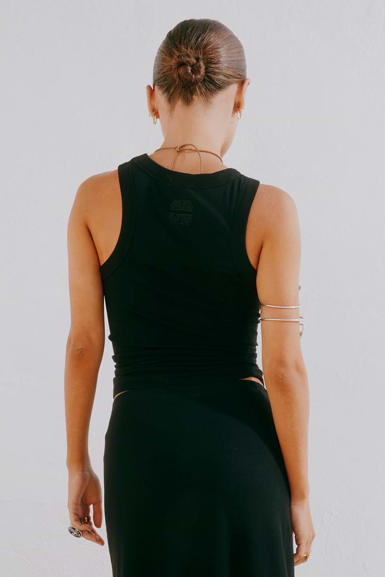 Black Sol Tank Top featuring a racerback with tonal embroidery, shown from the back in a ribbed black fabric.