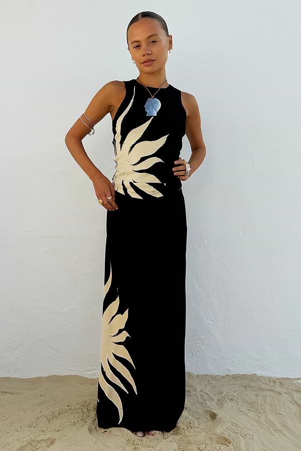 Black Sol Tank Top with an in-house designed cream sun motif, paired with a matching maxi skirt for a beach holiday look.