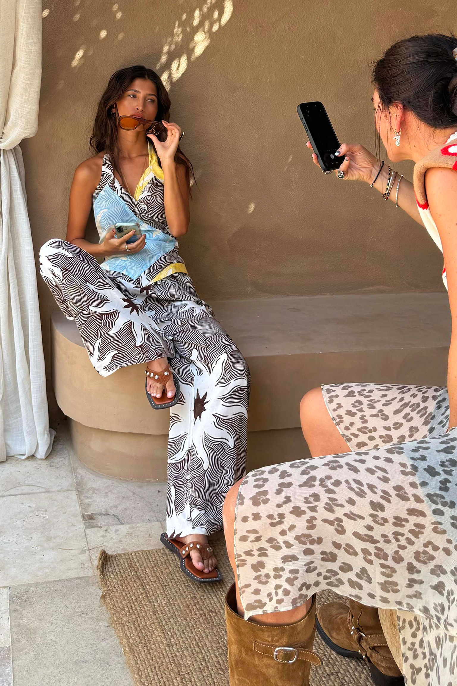 Chocolate Soleil Ellie Trousers and wrap top in a sun motif, styled as a wide-leg co-ord in a Mediterranean setting.
