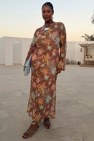 Star Fawn Aria Mesh Dress with sun and star motifs on sheer brown fabric, featuring flared sleeves.