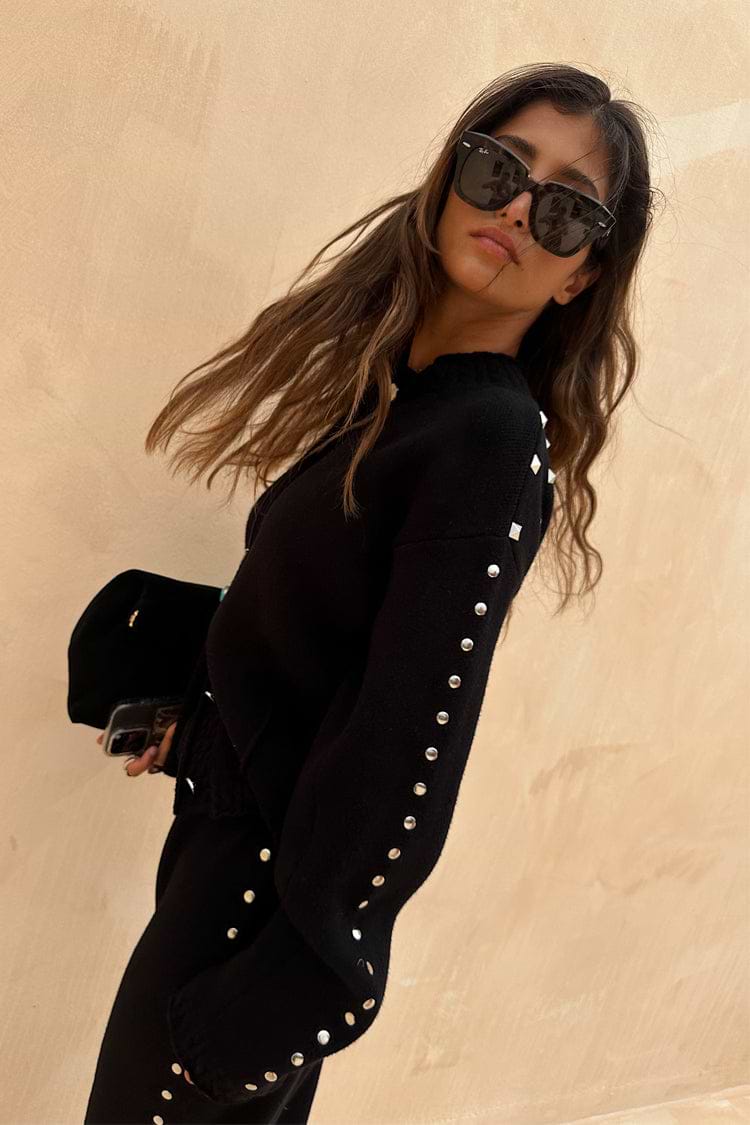 Black Studded Cardigan featuring silver metal studs on the sleeves and a structured fit, a versatile statement staple.