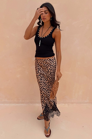 Black Studded Rib Vest featuring gold neckline detailing, styled with a leopard print lace-trimmed skirt.