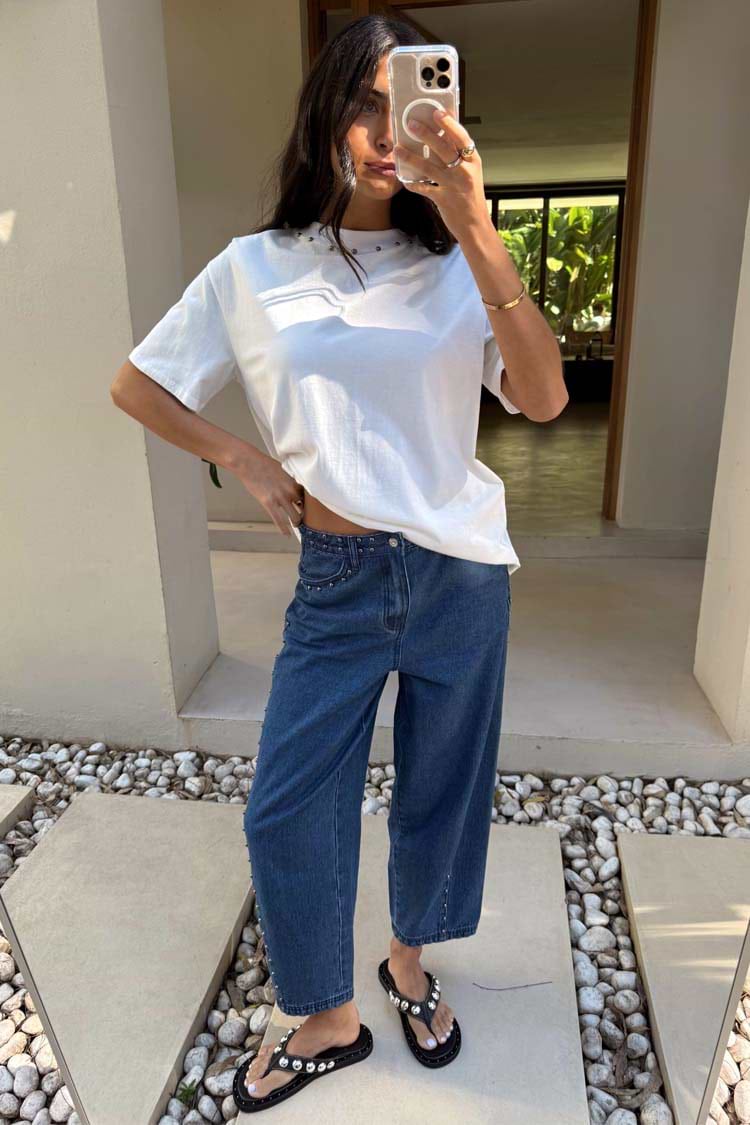 Blue Studded Barrel Jeans with side studs and a structured silhouette, styled with a white t-shirt.