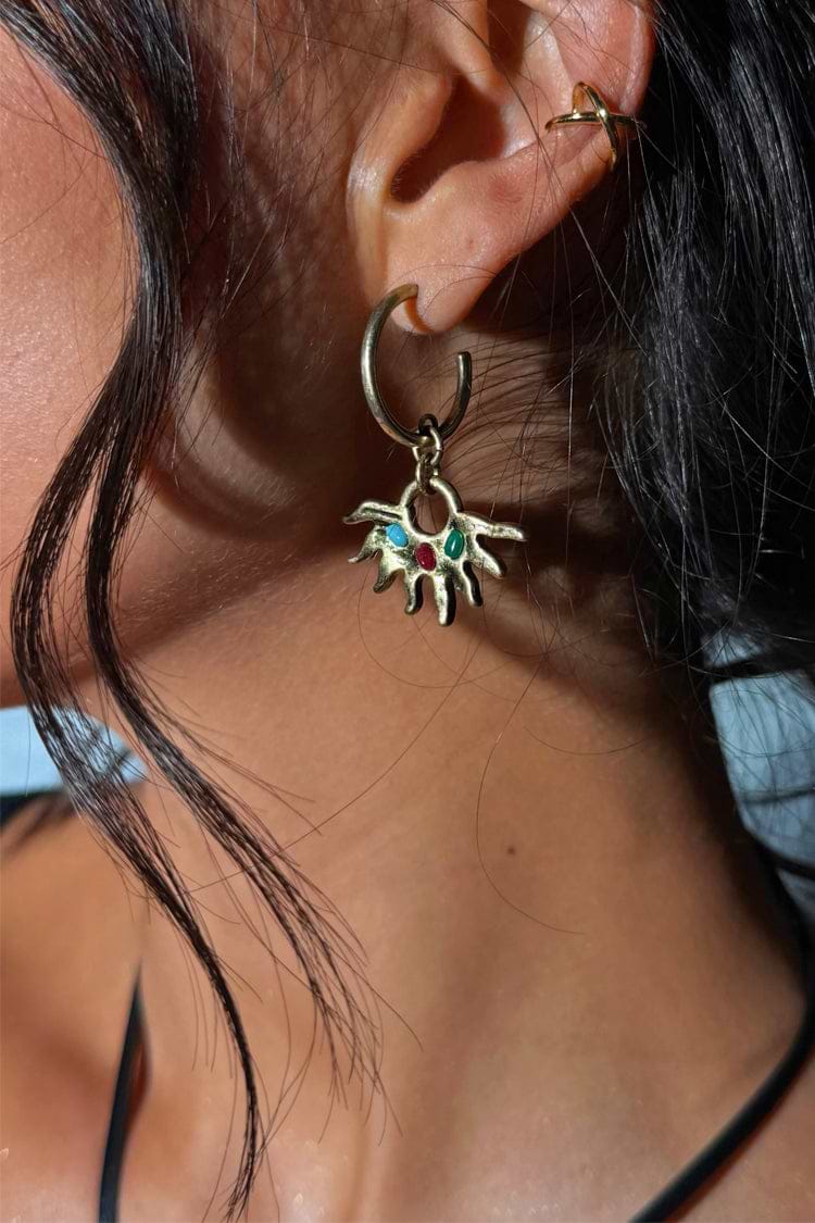 Deloris Sun Hoop Earring with gold-tone sun motif and semi-precious stones, styled on a model’s ear.