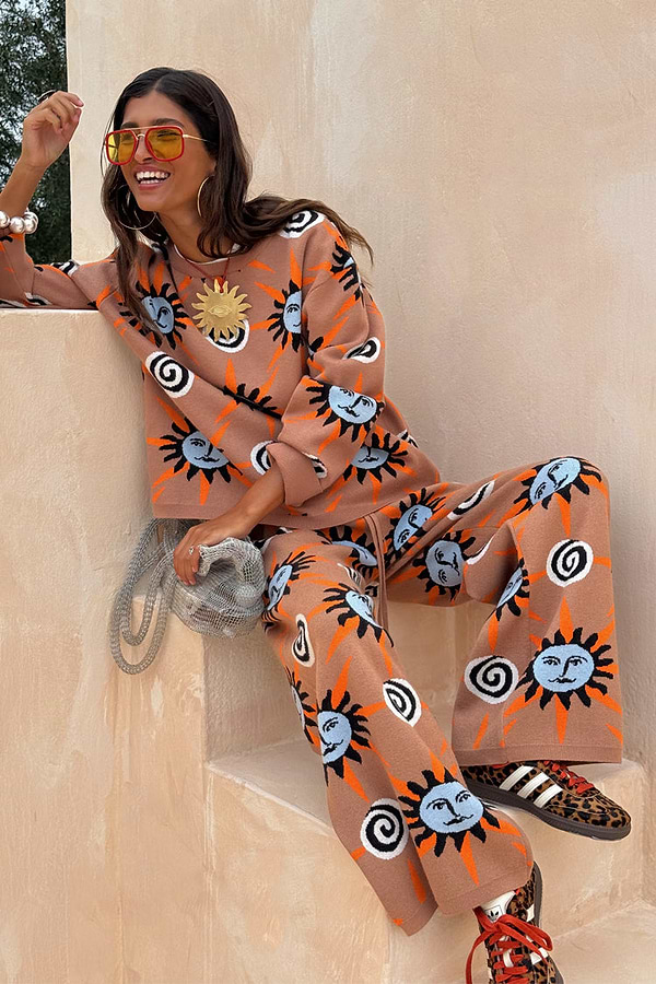 Tan Sun Trousers in a soft stretch knit with a sun and swirl motif, styled as a co-ord set on a model.
