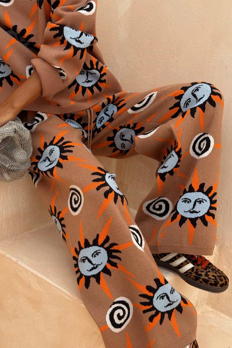 Tan Sun Trousers in a stretch knit featuring sun and swirl motifs, styled as a co-ord with leopard trainers.