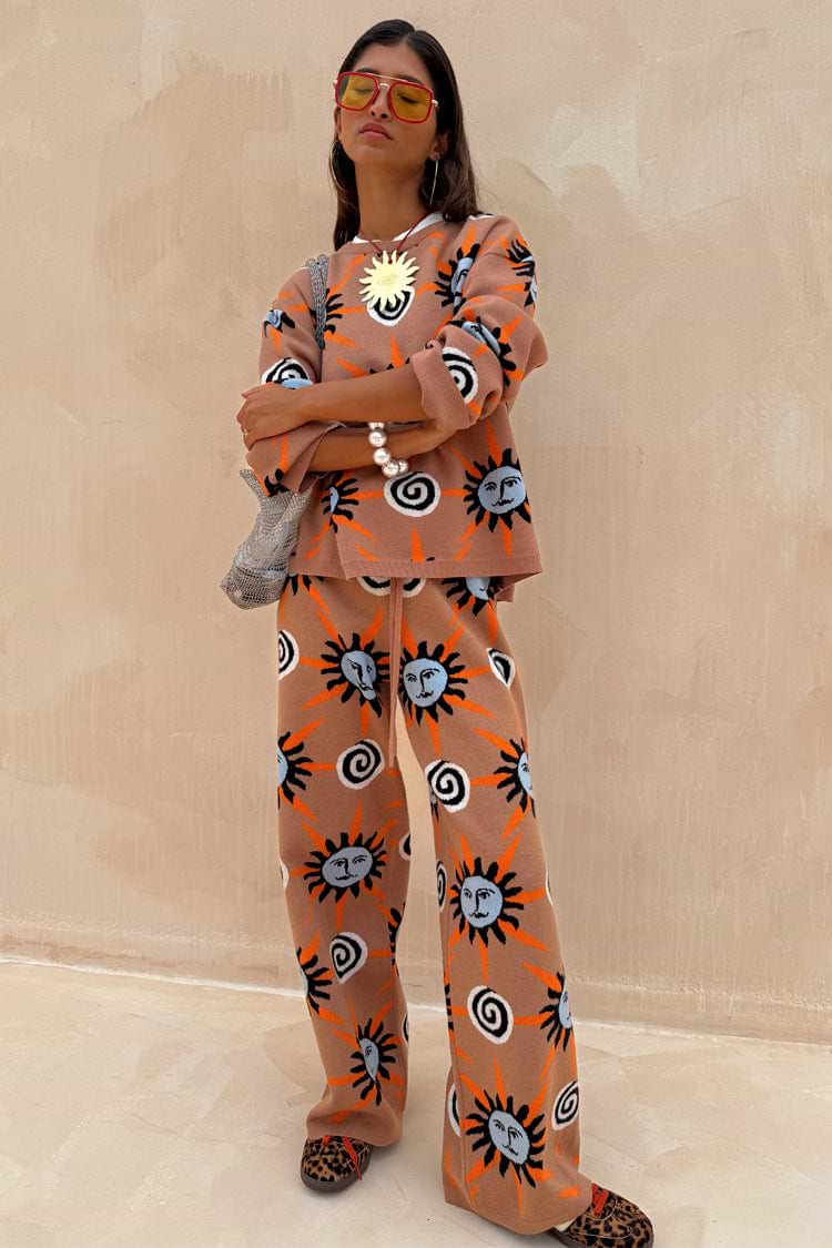 Tan Sun knit trousers with sun and swirl motifs, styled as a co-ord. Model is 5ft4” and wears size M.