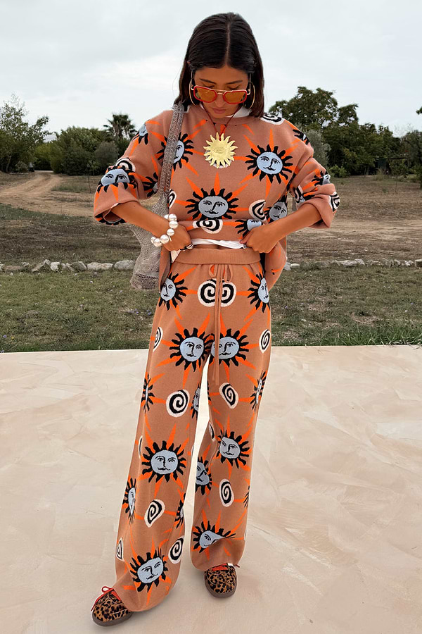 Tan Sun Trousers with sun motifs in stretch knit, styled as a co-ord on a 5ft4 model wearing size M.
