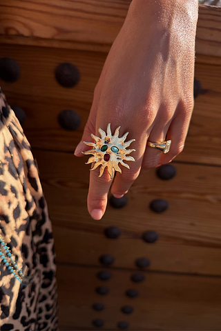 Deloris Sun Ring in brass with semi-precious stones and an iconic sun motif, styled with leopard print.