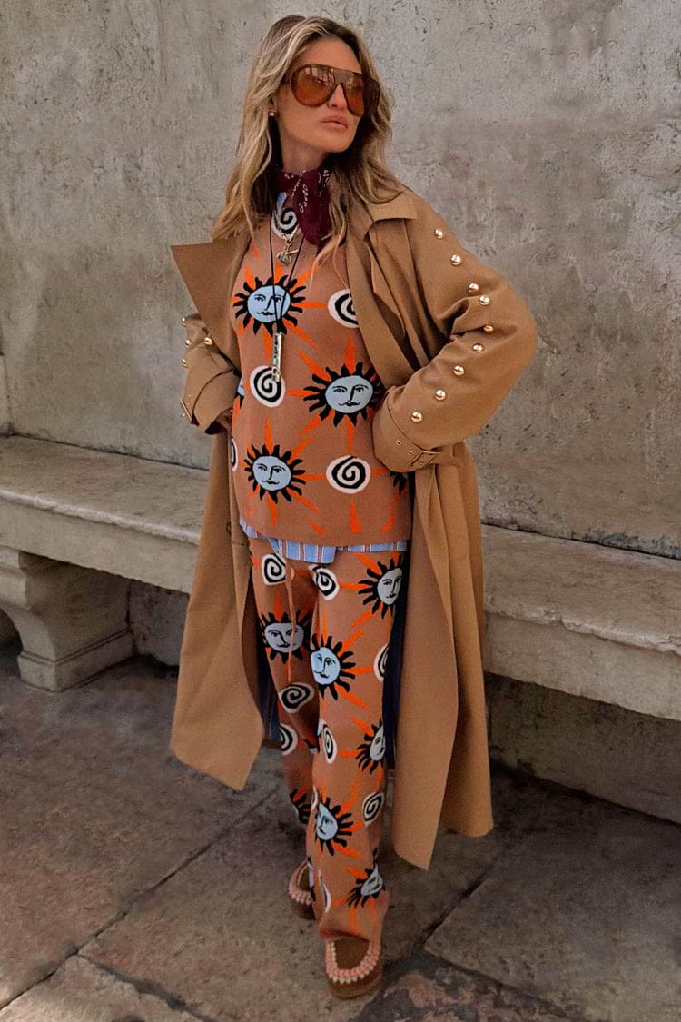 Tan Sun Copenhagen Jumper with hand-painted sun motifs, styled as a co-ord under a tan trench coat.