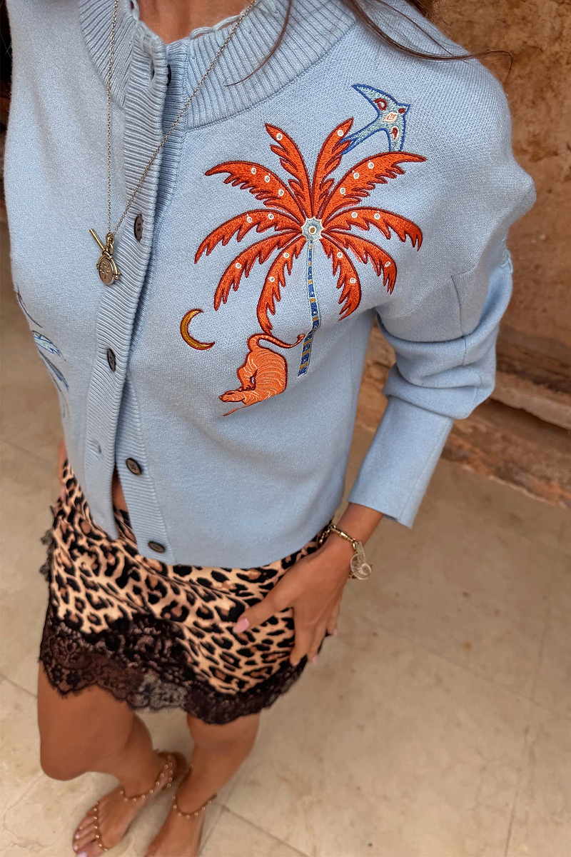 Blue Tigress Cardigan with embroidered palm tree and tiger, paired with a leopard print and lace skirt.