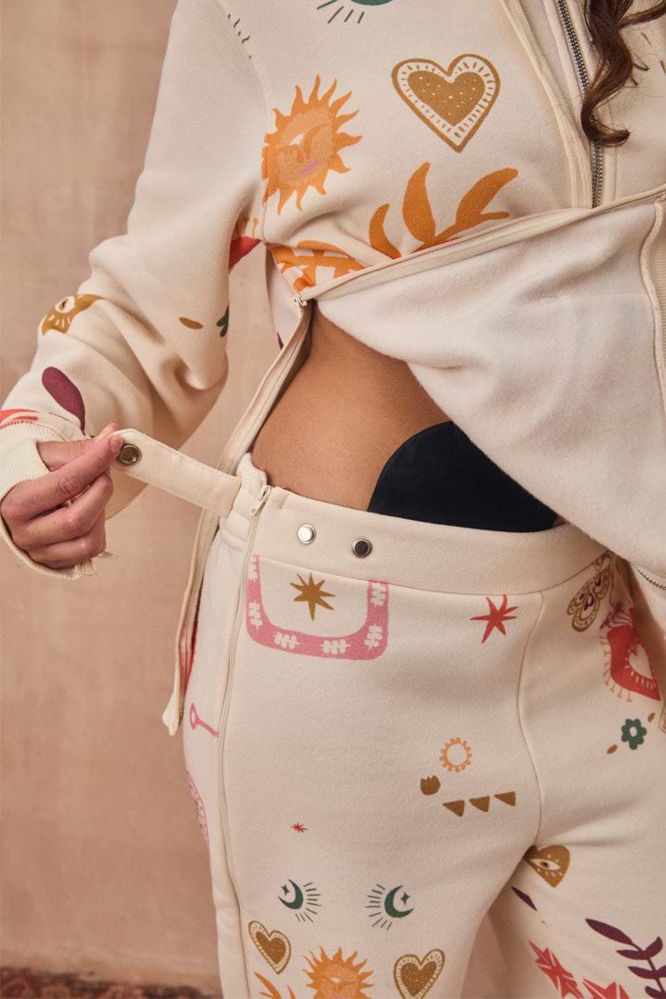 Cream Sundazed Accessible Joggers featuring side zips and poppers for treatment access and iconic prints.